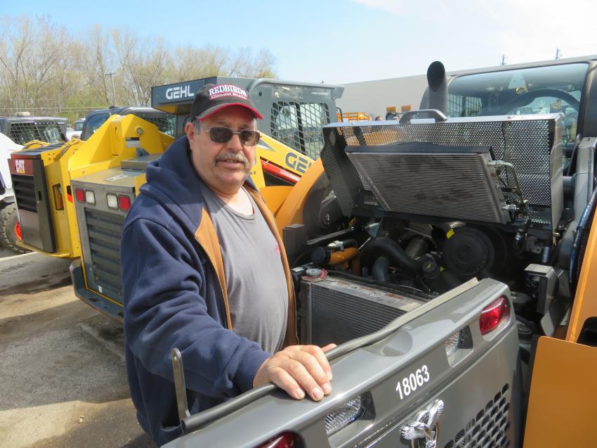 Bill Williams of Williams Enterprises looks over the engine of a Case SV280 skid steer.
