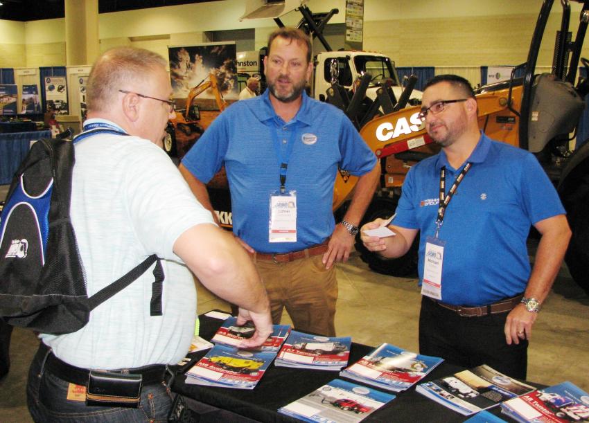 (L-R): An APWA delegate  stops at the Trekker Tractor exhibit to talk with Schwarze Industries’ Latner McDonald and Trekker’s Michael Cabrera. Trekker recently took on the Schwarze line, and the show provided the perfect venue to promote the sweeper line.