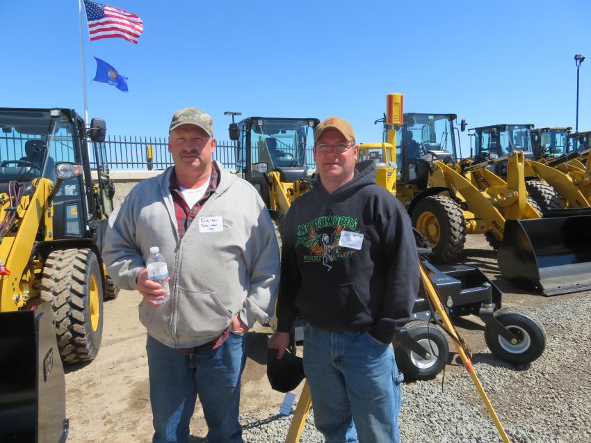 Randy Kern (L) and Berry Biller, owner of Biller’s Lawn Care Service, check out all the grading systems on display at the season opener.
