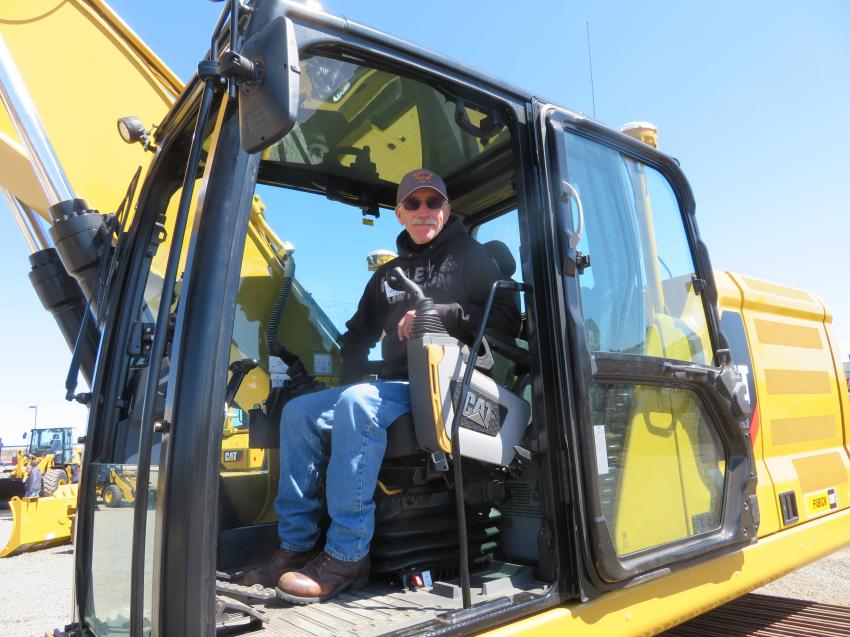 George Jackson of Jackson Trucking & Excavating settles into the cab of a Cat 323.

