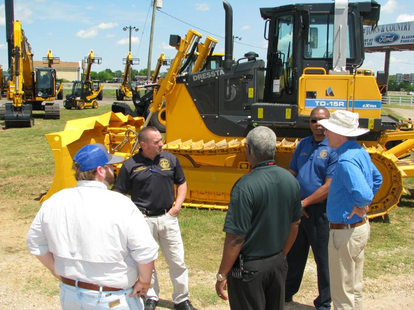 Southland Machinery/JCB of Alabama owner Mark Long (R) talks with staff members of the city of Birmingham about some of the machines of interest and on display at the event.