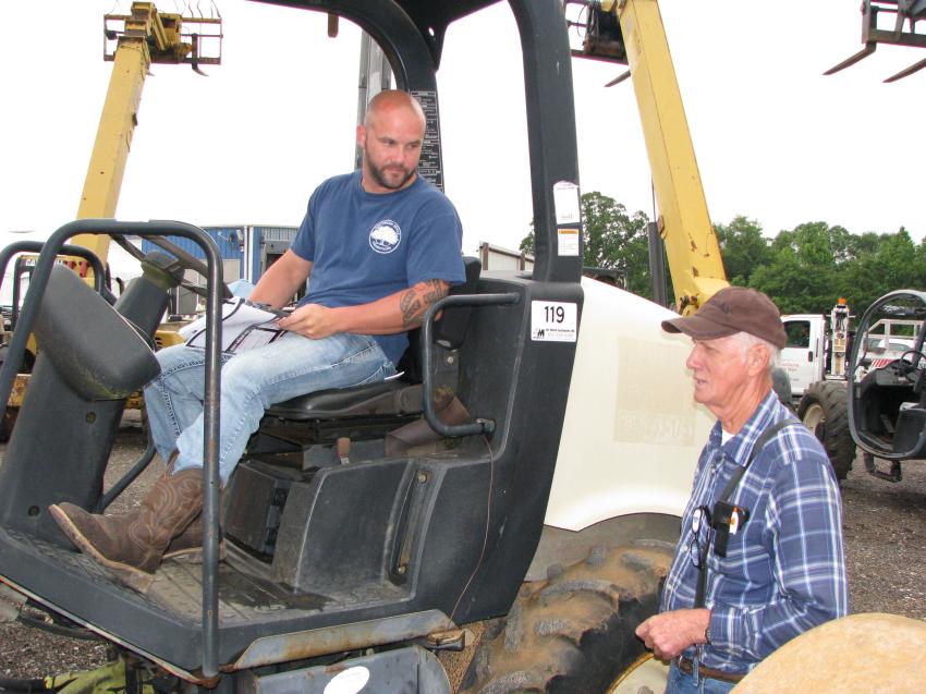 Wesley Gatwood (L) of Gatwood Southern Homes and James Gatwood of James Gatwood Timber, both based in Sumrall, Miss., talk about the lineup of machines in the sale.
