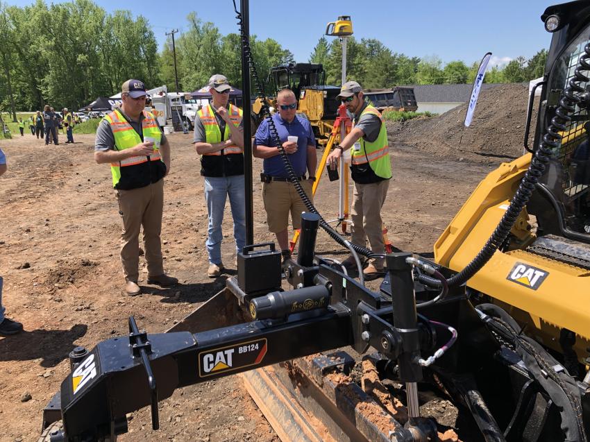On the left are Joel Reynolds and Patrick Whitlock, both of Blanchard Machinery.  Jeremy Peterson of Superior Grading listens to Andrew Lanford (R) of Blanchard Machinery as he points out a few of the benefits of the Cat 299 compact loader featuring Trimble Earthworks Go!