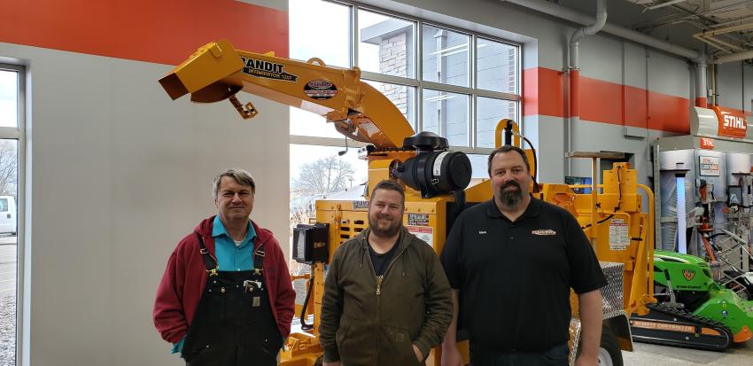 (L-R): John Buelow and Andy Buelow of Stillwater, Minn., check out this Bandit Intimidator 12xp with Tri-State Bobcat Little Canada Service Manager Mark Larson.
