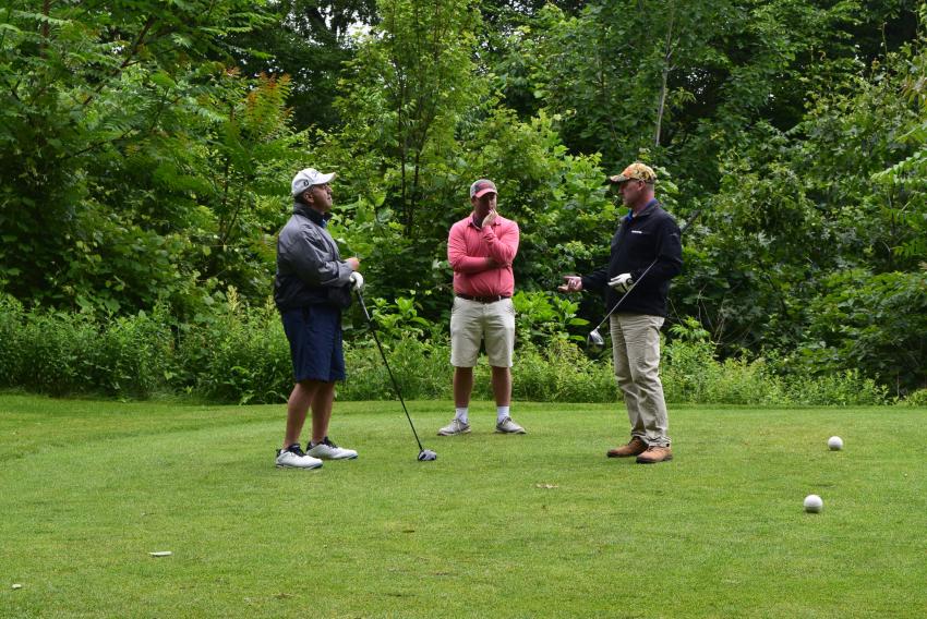 Armand Pizza of Komatsu (L) and Mark Hufcut of Pine Bush Equipment (R) take a break to chat with CEG Executive Publisher Teddy McKeon before teeing off.
