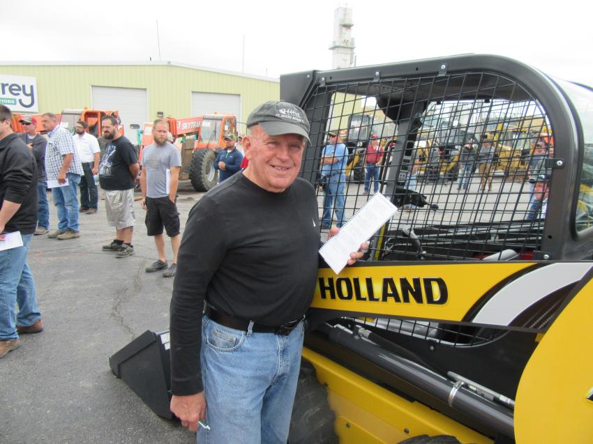 In from Jamestown, N.Y., Phil Baker of Phil Baker Construction admires a New Holland L213 skid steer loader.
