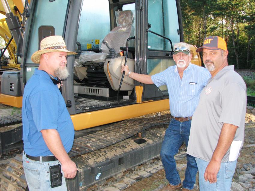 (L-R): Jeremey Yates and Danny Taylor, independent contractors from Woodland, Ala., and Tim Thompson, Thompson Grading & Clearing, Carrollton, Ga., check out a nice Case 130B excavator.
