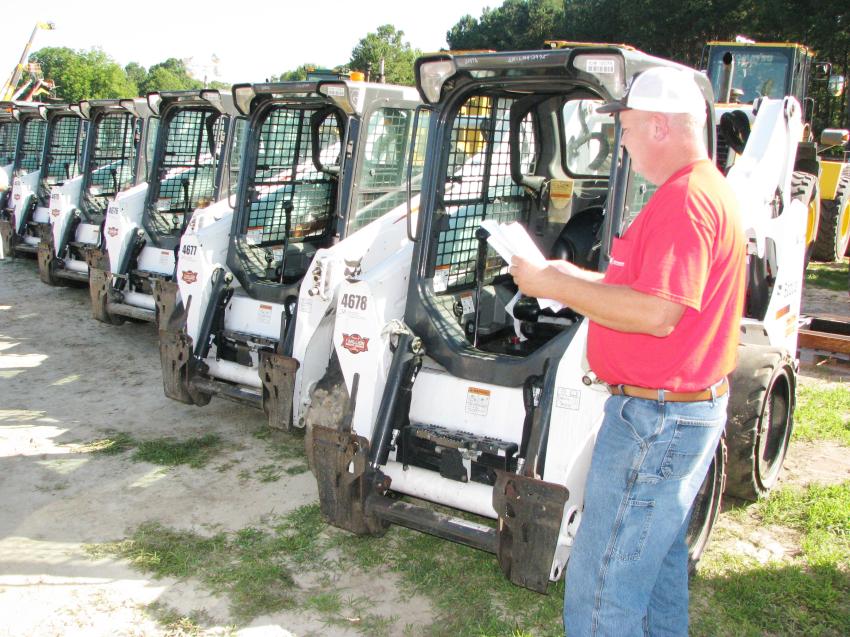 He calls himself the Iron King, but everyone else knows him as Mike Clower of Mike’s Heavy Equipment, Douglasville, Ga. Clower has his work cut out for him as he inspects the 12 Bobcat S570s at the auction site.