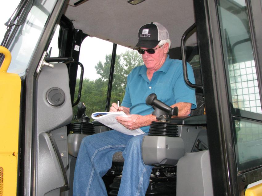 Larry Todd of Todd Builders, Lexington, Ky., takes a few notes on some Cat D4K dozers he intends to bid on once he settles into the auction theatre.