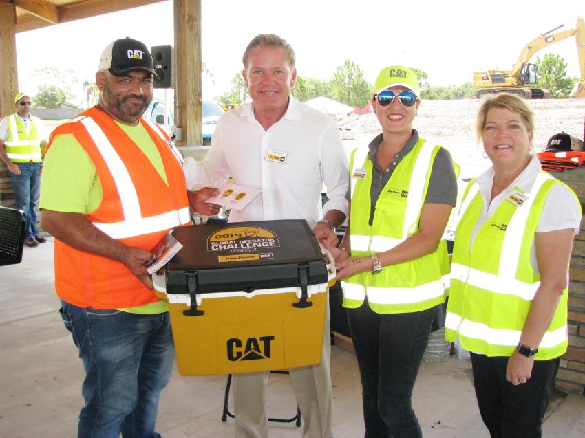 (L-R): Theodoros Fetsis of AAA Services, Clearwater, Fla., receives the $500 first place prize money and a Cat cooler from Ring Power’s Chris Zeras, Nimsay Montgomery and Sue Miller. 