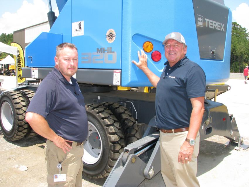 Jason Franklin (L), City of Hoover, Ala., public works supervisor, talks with John Van, North American sales manager of Terex Fuchs, about the MHL 320 material handler on the yard in Graysville. 