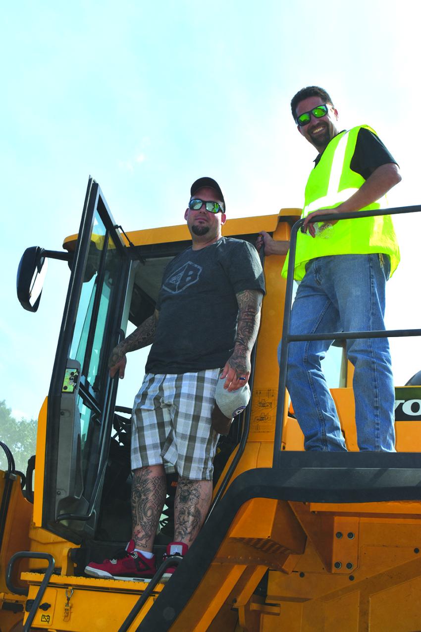 Anthony Foglio (L) of Foglio Inc. takes a Volvo L250H for a test drive after a brief tutorial from Chadwick-BaRoss’ Adam Lampron.