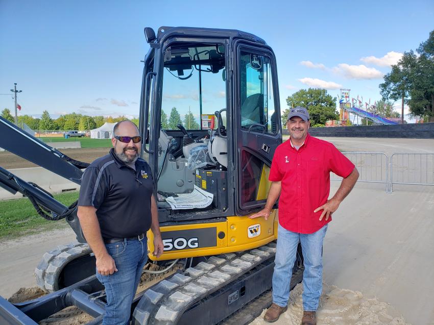 Lindsay Young (L) of West Side Tractor Sales Company shows off this John Deere 50G mini-excavator to Gene Frieders of the Sandwich Fair Association Board. 
