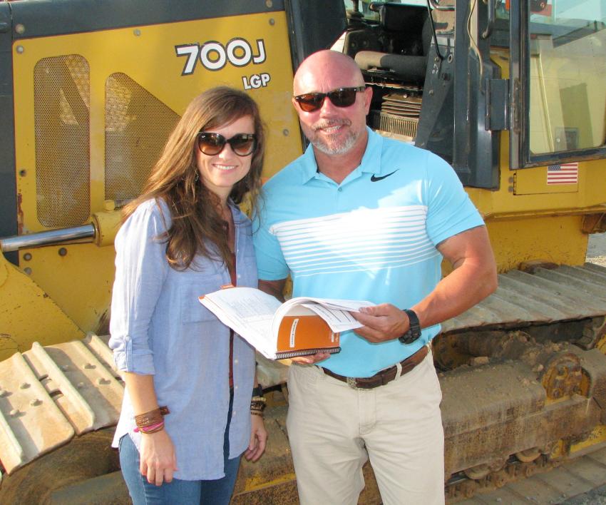 Looking over some of the dozers for their farming operations are Brandi Holloway and Jim Dunn III of Dunn Farms, Roanoke, Ala.   
