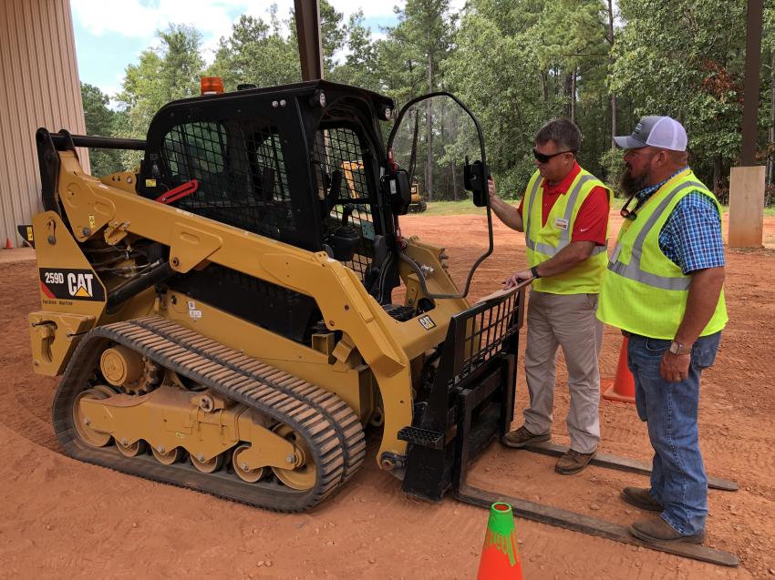 Ray Pippin (L) with Gregory Poole Equipment Company goes over the Cat 259D compact track loader with Mike Rutherford of Evergreen Clearing in Wilmington, N.C.
