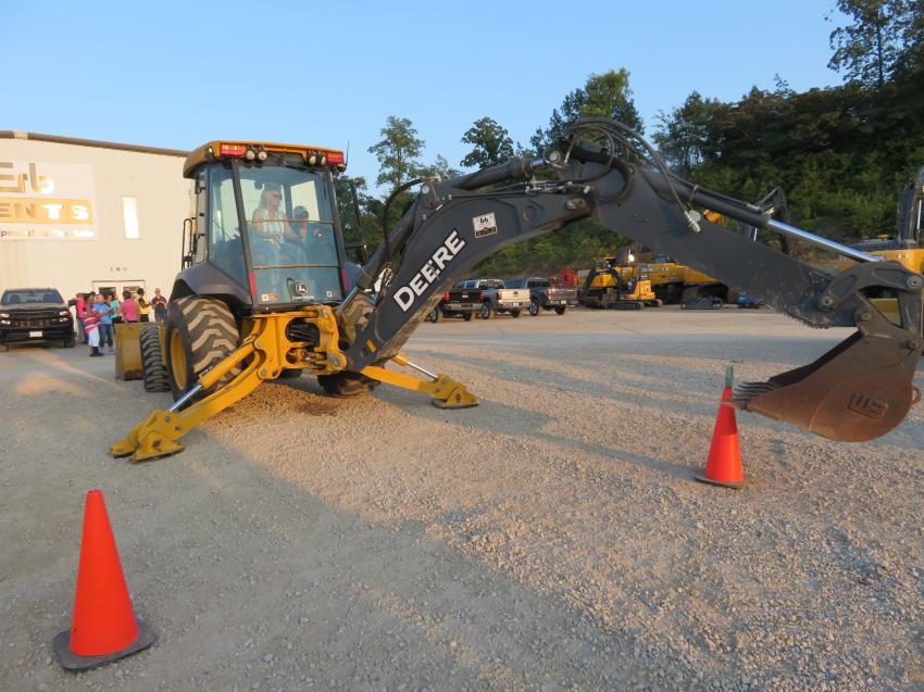 Operators show off their operating skills by competing in the ring competition with this John Deere 410SL backhoe loader. 
