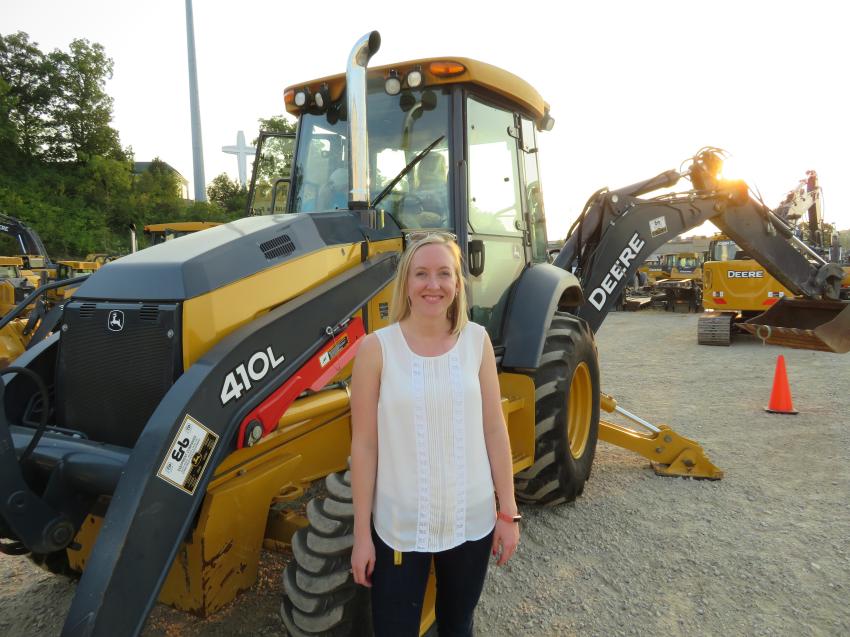 Laura Switzer of the Lawrence Group gets set to try out this John Deere 410SL backhoe loader.
