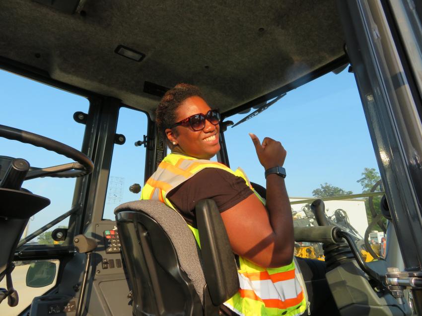 Megan Banks of S.M. Wilson & Co. is all set and ready to go in the cab of this John Deere 310SL backhoe loader.
