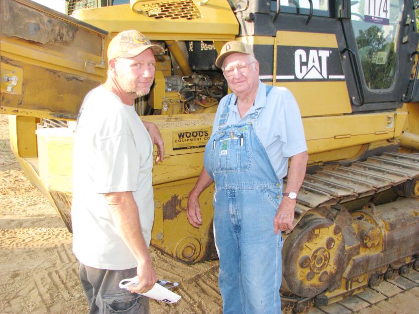 Opening up a Cat 953C crawler loader of interest are Gary Horton (L) and Erwin Horton of Horton Logging, Columbiana, Ala.