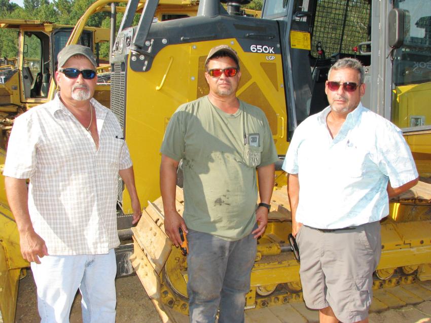 Checking out several really nice John Deere 650K dozers available in the equipment lineup (L-R) are Willie Jordan of Jordan Timber Co., Calvert, Ala.; Terry Rivers of TLT Timber, McIntosh, Ala.; and Rodney Jordan, also of Jordon Timber Co.