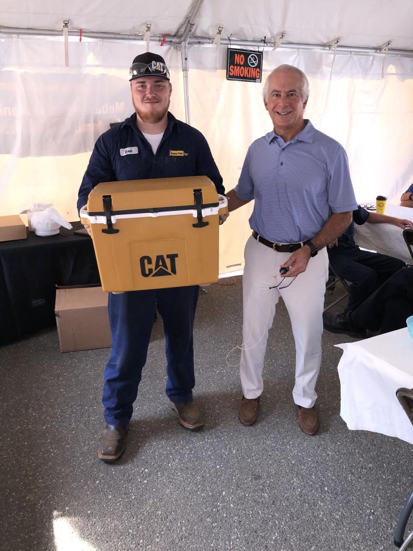 Many raffle items were given away; here Evan Griffith receives the grand prize from Greg Poole.
