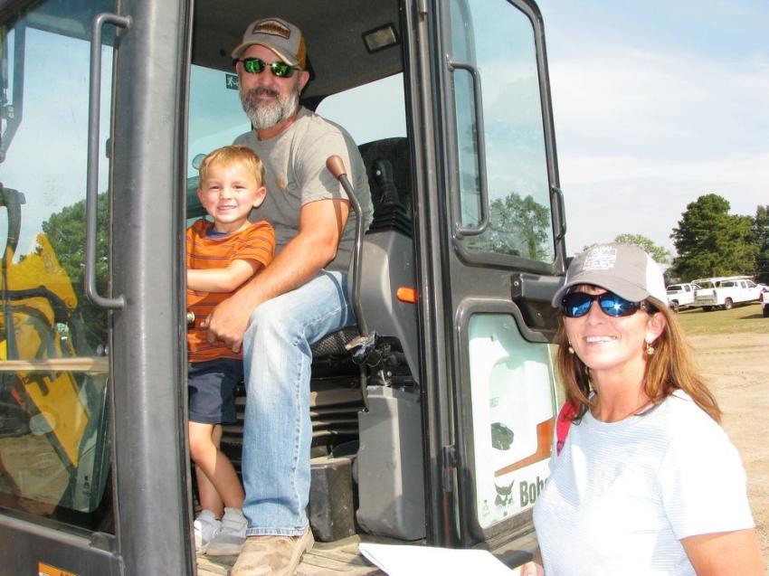 Auction time was family time for (L-R) Asher, Glenn and Monica Ladner of L&L Maintenance, Repair & Construction, Pass Christian, Miss., who were busy inspecting a Bobcat E55 mini-excavator.