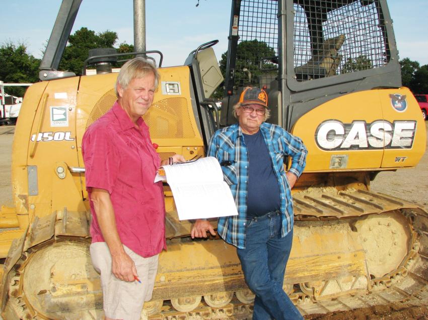 Looking over and discussing their thoughts on a Case 850L dozer in the sale are Ronnie Steitler (L) and Bobby Simpson of Steitler Timber & Allied Construction, Texarkana, Texas.