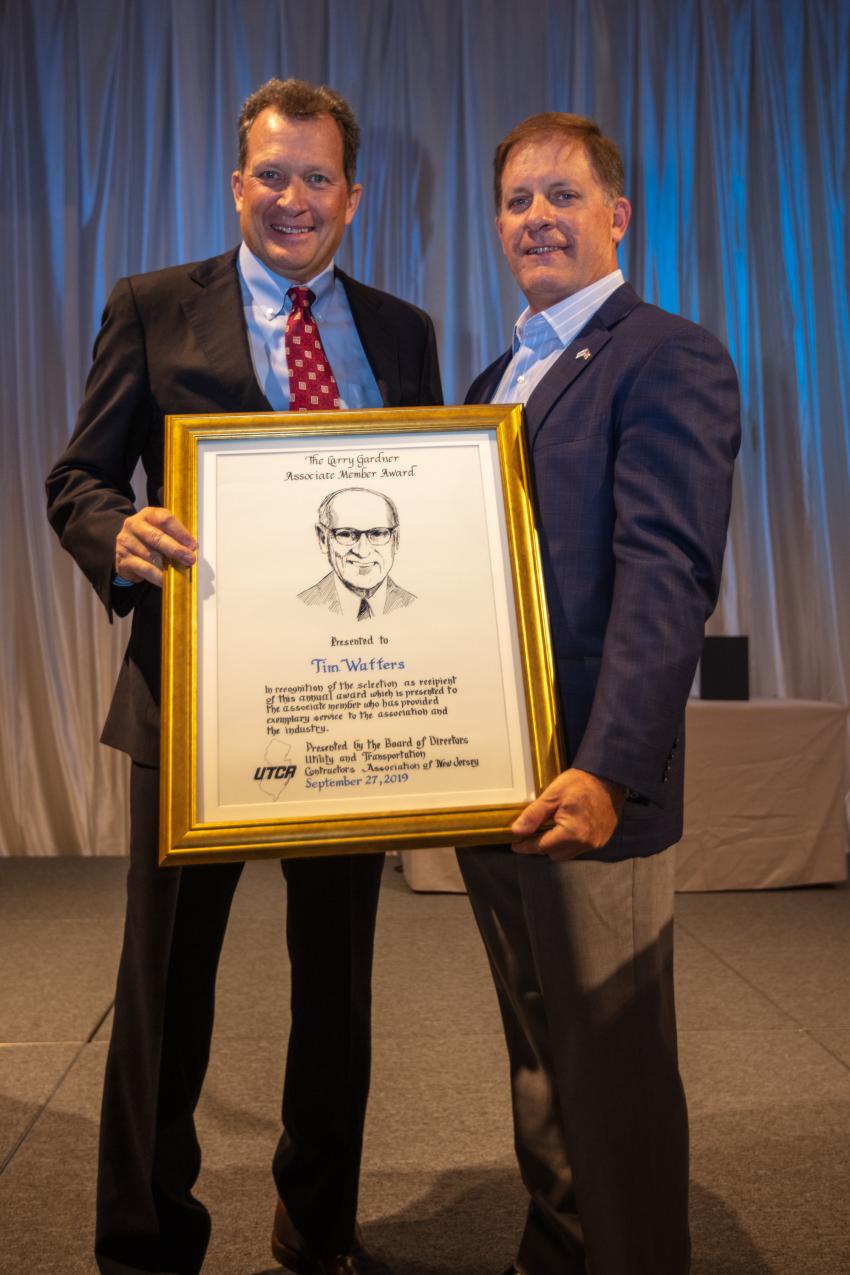 UTCA President Dave Smith (R) presents the Larry Gardner Memorial Award to Tim Watters, president of Hoffman Equipment.