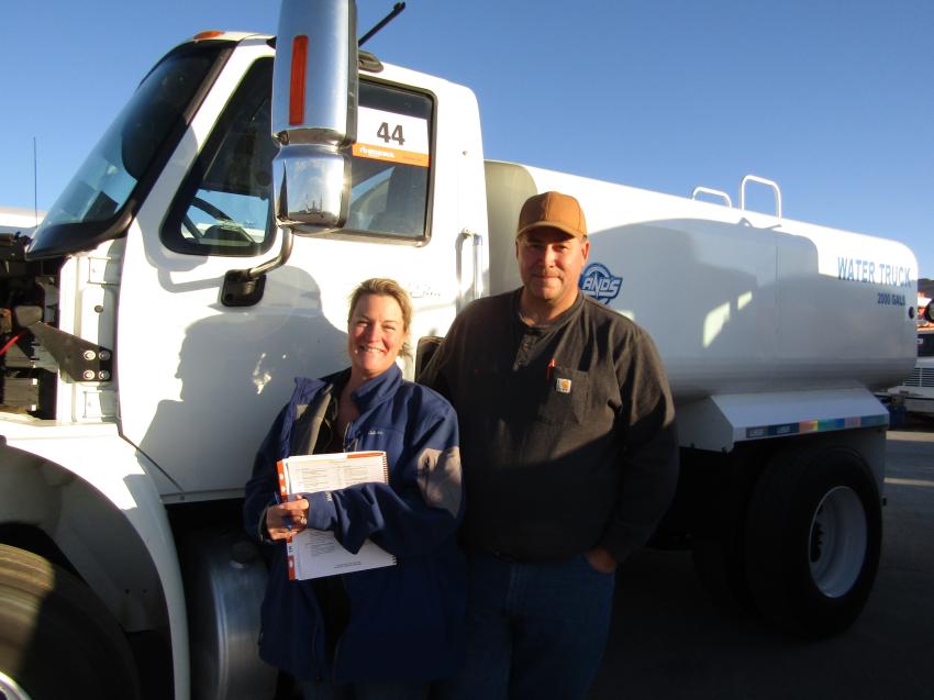 Husband and wife team, Stephani and Bryan LeBlanc checking under the hood of this 2013 International Durastar 2000 gallon water truck for potential purchase.
