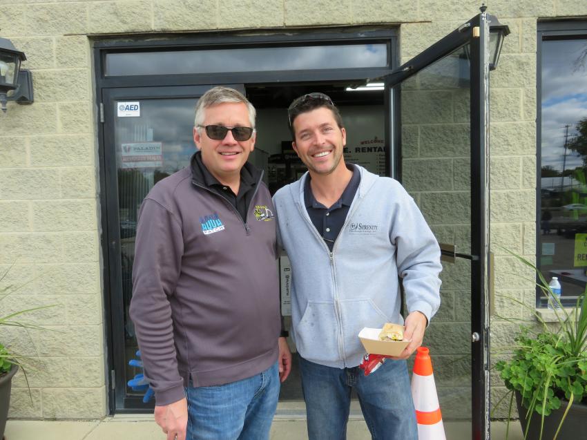 Robert Sloan (L) president of Contractors Equipment Rentals, welcomes Gary Berkshire of Serenity Landscape Design Inc. to the second annual Oktoberfest in Elmhurst, Ill.
