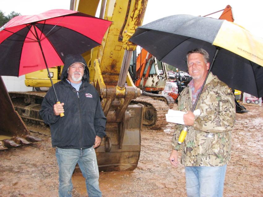 A bit of wind and rain didn’t dampen the enthusiasm of a day at the auction for Grady Smith (L) and Harlan Martin of Martin Construction and Grading, Toccoa, Ga.