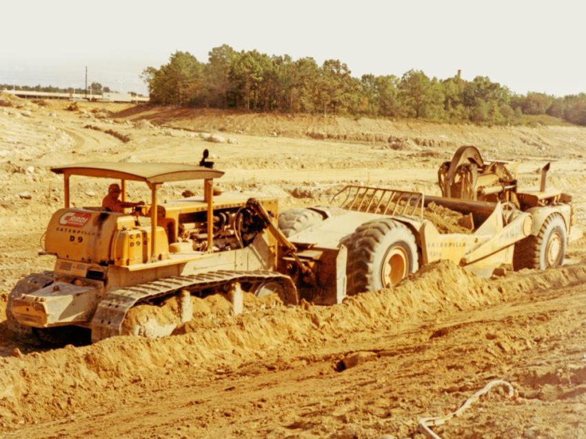 Cardi Corporation’s first major highway project was a $3,157,000 contract awarded in 1970 for a 2 mi. segment of Route 140 in New Bedford, Mass. The photo depicts a Caterpillar D9G tractor push loading a Caterpillar 631B scraper, one of six on the project.
(Cardi Corp. photo)