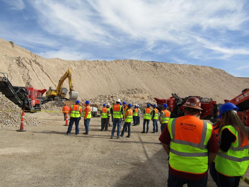 Attendees gather to watch a demonstration of the Terex Finlay aggregate machines in action.
