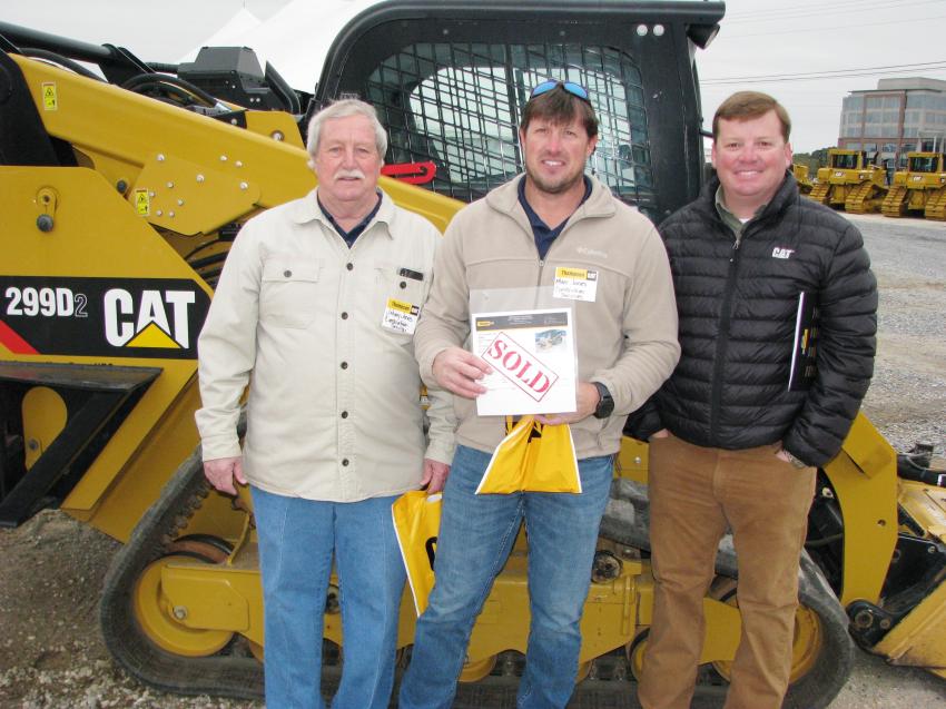 Proud new owners of a Cat 299D compact track loader (L-R) are Johnny Jones and Marc Jones of Construction Services in Prattville, Ala., and their Thompson Tractor sales representative, Hardy Traylor.