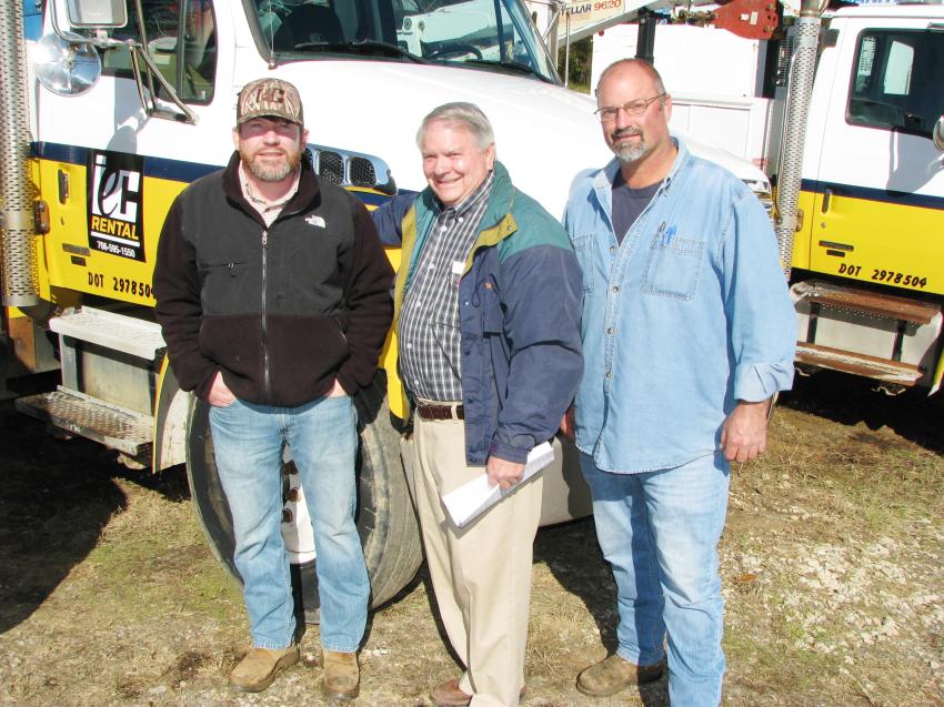 Some of the machines and service trucks in the sale lineup came from Thomson-based Interstate Equipment Company (IEC). Monitoring the pricing of their sale items are Jon and Paul McCorkle and Danny Beckworth of IEC.