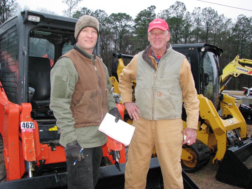 Looking over some of the skid steer and compact track loaders of interest are Aaron McGrew (L) and his dad Eric McGrew of Sunset Farms, Bowdon, Ga.