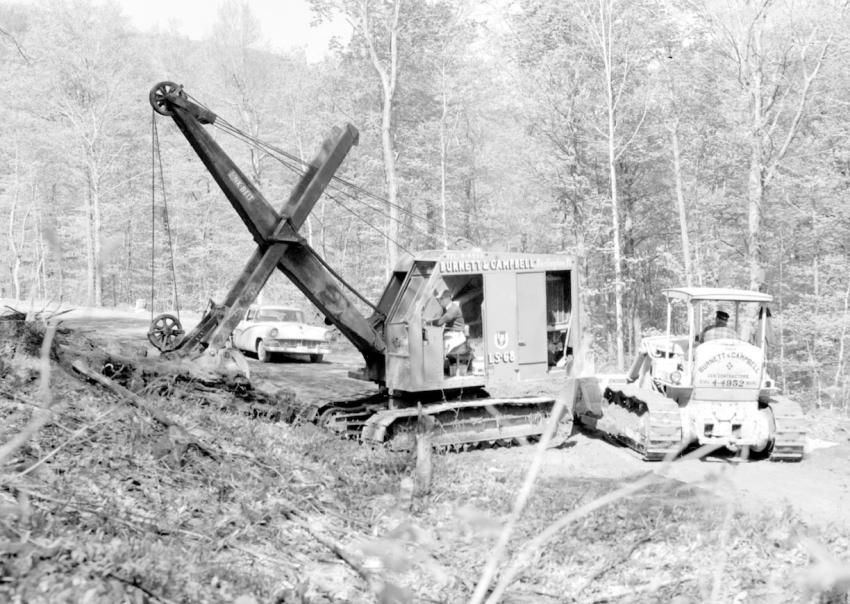 In Vermont — Burnett & Campbell of Burlington, Vt., held a $359,158 contract for a 1.288 mi. road improvement project in Ferrisburg, Vt., during 1958. The contractor here is using a Link-Belt LS-68 shovel and a Caterpillar D6 bulldozer.
(Vermont State Archive photo)