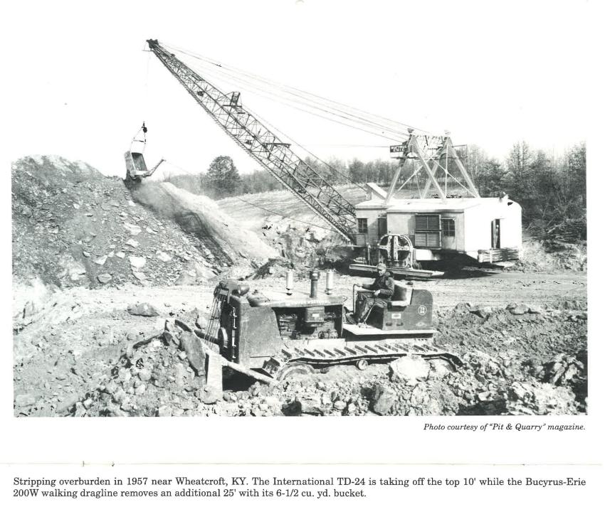 Stripping overburden in 1957 near Wheatcroft, Ky., the International TD-24 is taking 10 ft.off the top while the Bucyrus-Erie 200W walking dragline removes an additional 25 ft. with its 6-1/2 cu. yd. bucket.
(Pit & Quarry Magazine photo, HCEA Archive)