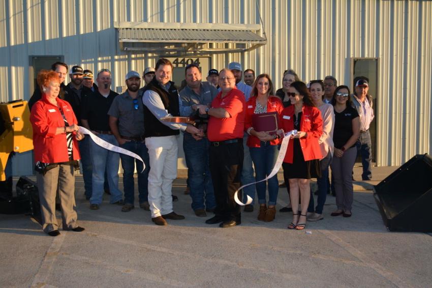 Whit Perryman (center with black vest), CEO of Vermeer Texas-Louisiana and Compact Construction Equipment, cuts the ribbon to officially open the companies’ new branch in Victoria.