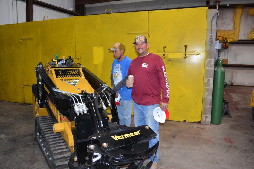 Manuel (L) and Alex Padilla of Vics Plumbing said they could really put the Vermeer CTX100 mini skid steer to use in the plumbing business.  The CTX100 on display was equipped with a log grapple.
