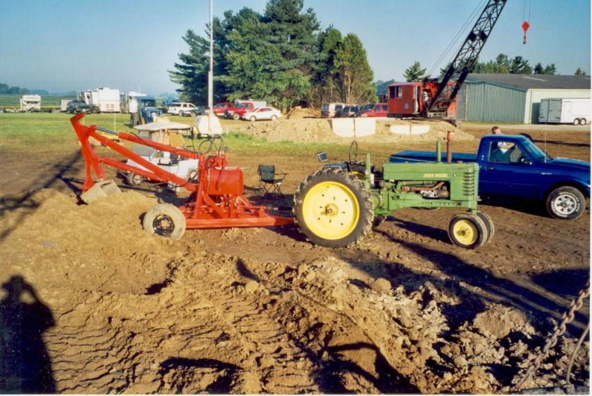 The tractor-operated backhoe is a 1951 Hopto (Hydraulically Operated Power Take Off), built by Badger Machine Company and is being run from a John Deere B tractor. These were the first known American true hydraulic excavators.
(Keith Haddock, HCEA Archives photo)