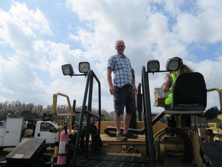 Danny Clark of Clark Heavy Equipment, based in Pleasureville, Ky., takes in the bidding activity at the Yoder & Frey auction.
