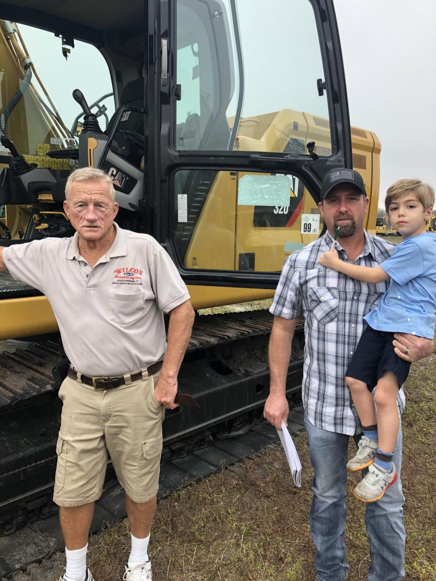 (L-R): Giving close inspection to a late model Cat excavator are Jerry Wilcox of Wilcox Excavating, South Windsor, Conn., and Mike Kubiszyn and his son, Major, of Universal Engine, Buffalo N.Y.