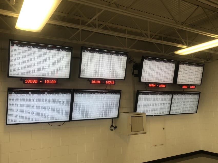 Screens show Ritchie Bros.’ timed auction lots.