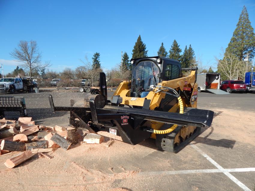Glen Halverson of Halverson Wood Products Inc., Pine River, Minn., demos its slick automated firewood processor. Makes quick work of logs that you can cut and split without leaving the machine.    

