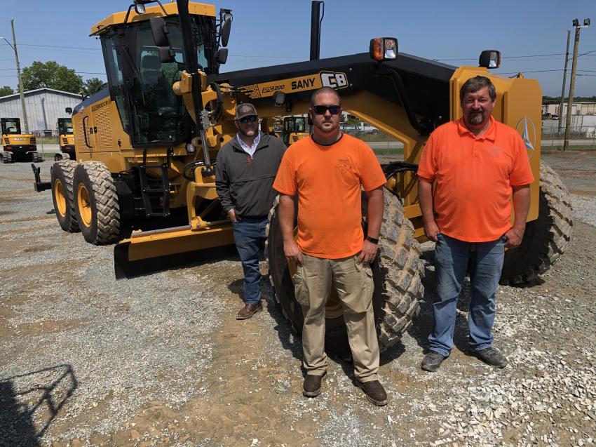 Joe Woods (L) of Ironpeddlers, and Tyler and Steve Sharpe, both of Carolinas Contracting in Camden, S.C., are with the newly introduced SANY SMG200C-8 motorgrader.