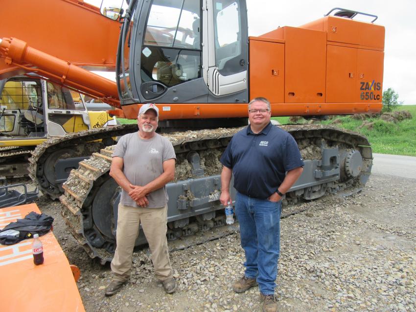 Brad Allar (L) of Triple A Construction spoke with RECO Equipment’s Dave Totterdale at the Marietta Coal Company auction. 
