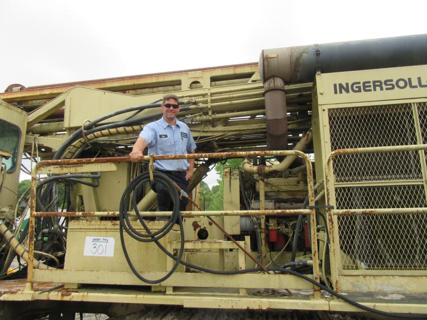 In from Kentucky, Harper Diesel and Machine Service’s Ben Harper inspects this Ingersoll Rand DM45 drilling rig to determine a bid price at the Marietta Coal Company auction. 
