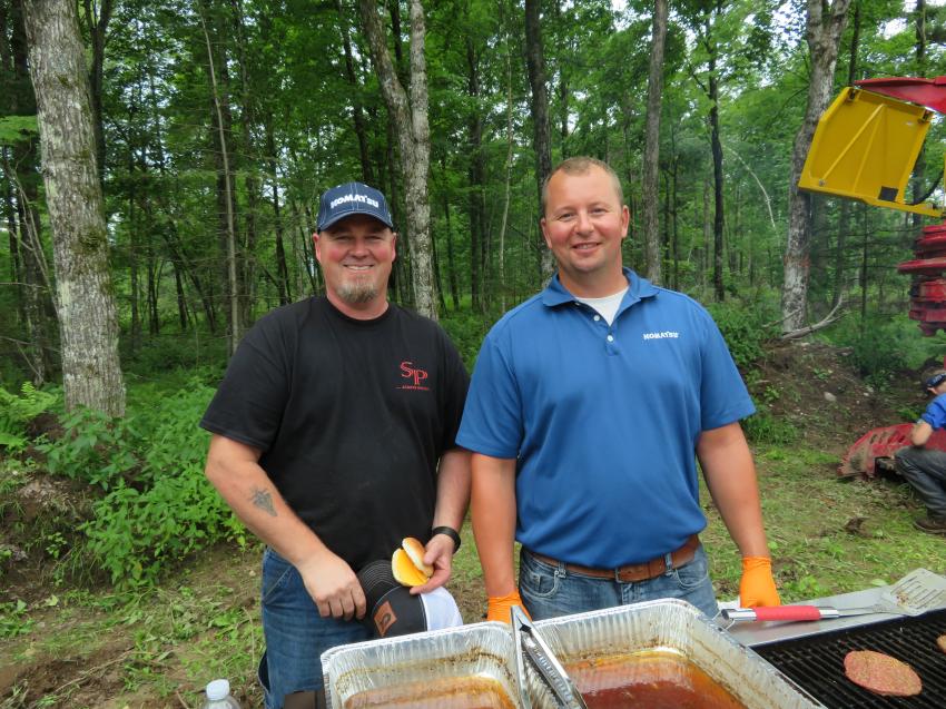 Todd Mihalko (L), owner of Todd Mihalko Logging, is served lunch by Eric Sixel of Roland Machinery Co.

