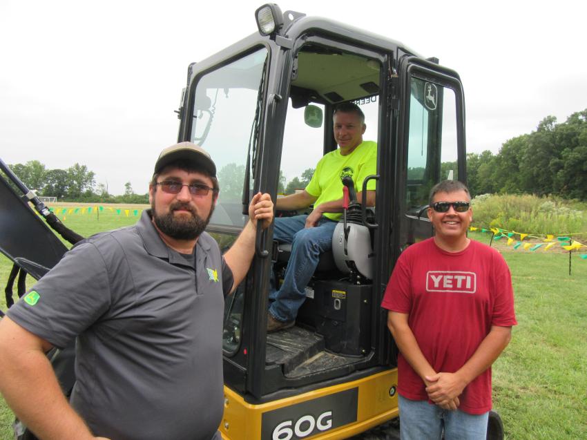 (L-R): Ag-Pro’s Easton Young reviews features of this John Deere 60G compact excavator with Chris Hildebrand and Shane Prewitt of Butler Township, who both appreciated the visibility from the operator’s position.
